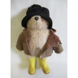 A Paddington Bear, with grey plush, moulded plastic nose, black felt hat, brown felt coat and yellow