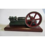A horizontal signal cylinder mill engine finished in green/red, on wooden base, 8" x 2" x 4", G (