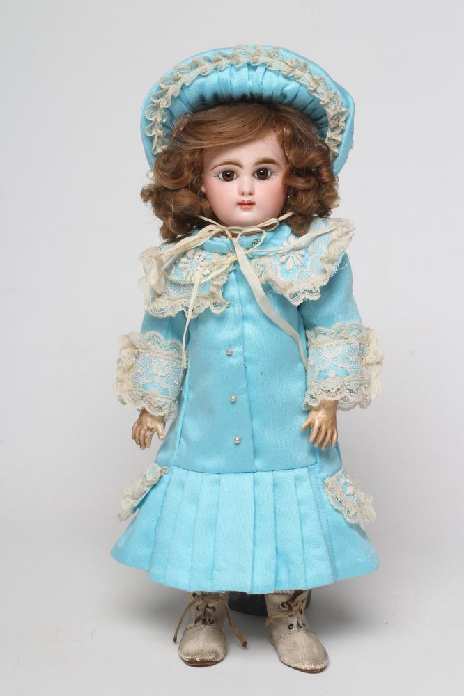 A Mascotte bisque socket head doll, with brown glass fixed eyes, closed mouth, pierced ears,