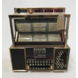 A Seeburg Consolette wall mounted juke box, 1960's, with coin operated system and turn knob song