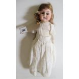 A German bisque socket head doll, with brown glass sleeping eyes, open mouth, teeth, cloth body,