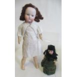 Two bisque socket head dolls comprising a 7 1/2" doll with blue glass sleeping eyes, open mouth