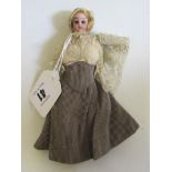 A bisque shoulder head dolls house doll, with brown glass fixed eyes, blond wig, bisque arms,
