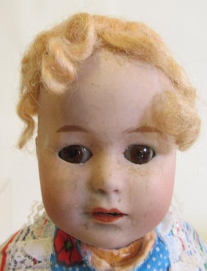 A Heubach bisque socket head doll, with brown glass fixed eyes, blond wig and composition body - Image 2 of 4