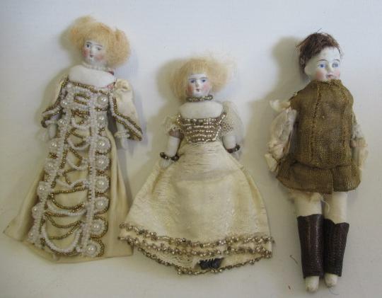 Three shoulder head dolls house dolls, comprising two similar ladies in beaded dresses and a boy
