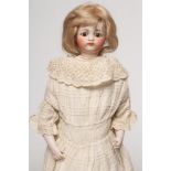 A Simon & Halbig bisque socket head doll, with brown glass fixed eyes, closed mouth, pierced ears,