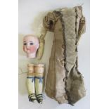 An early Limbach bisque head doll, with blue glass fixed eyes, closed mouth, composite limbs,