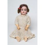 A Kestner bisque socket head doll, with brown glass sleeping eyes, open mouth, teeth, brown wig,