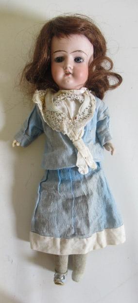 A German bisque socket head doll, with blue glass fixed eyes, open mouth, teeth, moulded eyebrows,