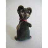 A small black velvet cat, possibly Steiff, early 20th century, with clear glass eyes and red ribbon,