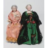 A pair of old lady bisque shoulder head dolls house dolls, with moulded hair, cloth bodies and