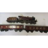 Hornby clockwork L.M.S. Compound Locomotive and two No 2 L.M.S. coaches, damage to paintwork and tin