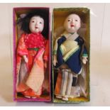 A pair of boxed oriental Moschemon dolls, with fixed glass eyes, and traditional attire, both 6"