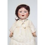 A Porzellanfabrik Burggrab "Das lachende Baby" bisque socket head character doll, with blue glass