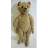 An early Steiff centre-seam teddy, with shoe button eyes, sewn nose and orange plush, 15 1/2"