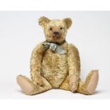 A pre-war Farnell Teddy, straw filled, with swivel joints, sewn nose, amber eyes, felt pads and