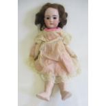 A Simon & Halbig bisque socket head doll, with brown glass sleeping eyes, brown hair, open mouth and