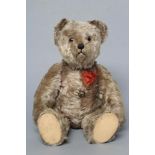 A pre-war Schuco yes/no musical teddy, with swivel joints, sewn nose, amber eyes, musical winder