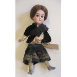 A Gebruder Knoch bisque socket head scotch doll, with green glass fixed eyes, open mouth, teeth,