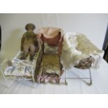 Two dolls beds and a raised crib, all of metal construction and the beds with scroll decoration,