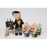 A pre-war Chad Valley pig school, 11 5/8" tall teacher, with tails jacket, hat, cane and label to