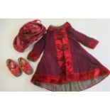 A set of Victorian Dolls clothing originally from a 28" Jumeau doll, comprising red velvet trim