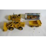 Four Caterpillar construction vehicles comprising Tractor Scraper, 769C Truck, Caterpillar Loader