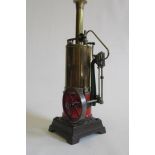 A single cylinder vertical toy steam engine fitted with water gauge, whistle and safety valve,