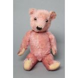 A rare pre-war pink Chiltern Teddy, with sewn nose, clear/black glass eyes, felt pads and jointed