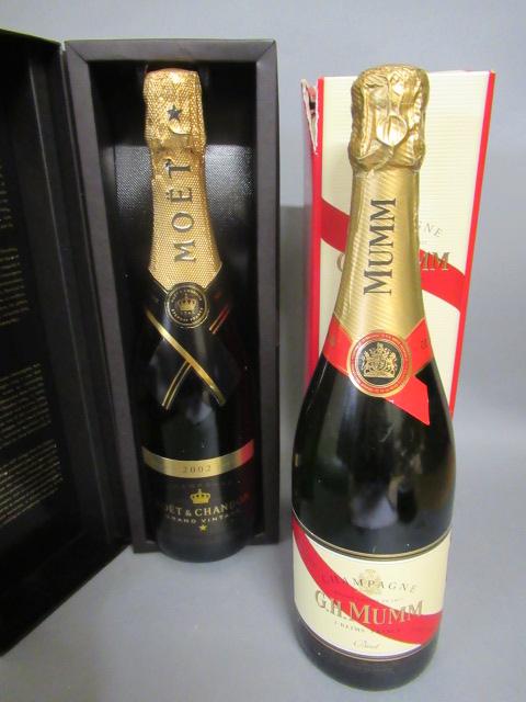 One bottle 2002 Moet & Chandon grand vintage Champagne, boxed, together with a G. H. Mumm cordon