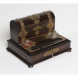 A VICTORIAN COROMANDEL INKSTAND of oblong form with brass mounts, the raised back with domed lid