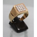 A GENTLEMAN'S DIAMOND SIGNET RING, the square panel point set with sixteen round brilliants to