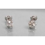 A PAIR OF DIAMOND SOLITAIRE EAR STUDS, the brilliant cut stones totalling approximately 0.7cts, claw