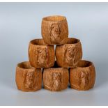 ROBERT THOMPSON, a set of six oak napkin rings of bellied faceted form, each carved with mouse