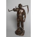 HANS MULLER (Austrian 1873-1937), Bronze figure of a farmer modelled standing with a scythe over his