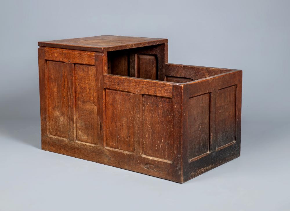 A ROBERT THOMPSON ADZED OAK LOG BOX, pre 1950, of panelled oblong form with one end raised to form a