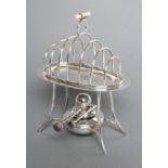 A SILVER TOASTRACK ON STAND WITH BURNER, maker Asprey, Birmingham 1911, the oval section seven bar