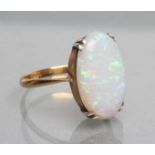 AN OPAL DRESS RING, the oval polished stone claw set to a plain shank, stamped PLAT, 18ct, size P