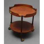 AN ITALIAN DESIGN TEAK TROLLEY, mid 20th century, of two tier circular form, the upper shelf with