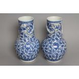 A PAIR OF CHINESE PORCELAIN VASES of baluster form, the necks with a moulded and applied serpent,