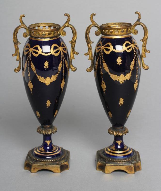 A PAIR OF FRENCH PORCELAIN GARNITURE URNS, c.1900, of slender ovoid form, the dark cobalt blue