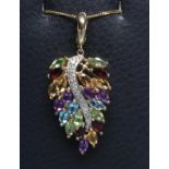 A MULTI GEM SET LEAF PENDANT, the marquise cut garnets, amethysts, citrines and other stones claw