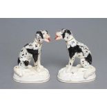 A PAIR OF STAFFORDSHIRE PORCELANEOUS BLACK AND WHITE SPANIELS, c.1830, modelled seated with free