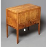 A GORDON RUSSELL WALNUT SMALL SIDE CABINET, c.1950, of rounded oblong form, the fascia with panelled