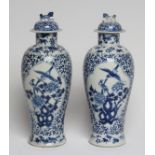 A PAIR OF CHINESE PORCELAIN VASES AND COVERS of inverted baluster form, painted in underglaze blue