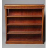 A LATE VICTORIAN MAHOGANY OPEN BOOKCASE, the moulded edged top over fluted frieze with applied