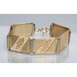 A BRACELET made up of six oblong panels engraved with flowers, clasps stamped 585, 41.8g (Est.