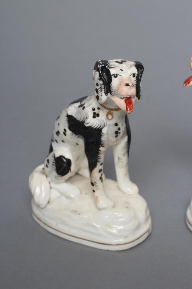 A PAIR OF STAFFORDSHIRE PORCELANEOUS BLACK AND WHITE SPANIELS, c.1830, modelled seated with free - Image 2 of 4