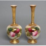 A PAIR OF ROYAL WORCESTER CHINA BUD VASES, 1917, with tall acanthus sheathed flared stems issuing
