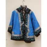 A CHINESE FUR LINED SILK JACKET, the insect woven blue silk damask with coloured silk embroidered